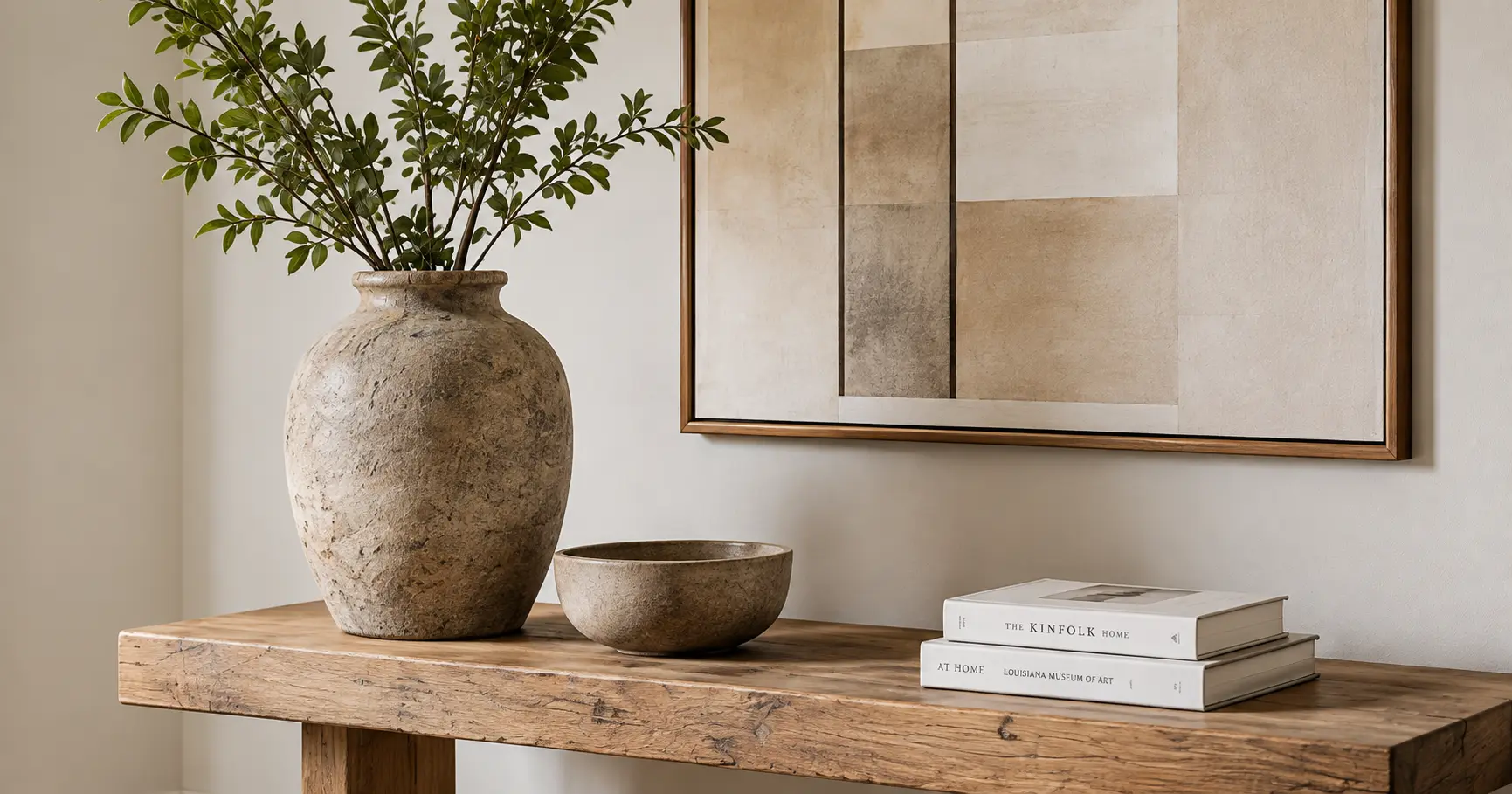 Styled console table with ceramic vase and books